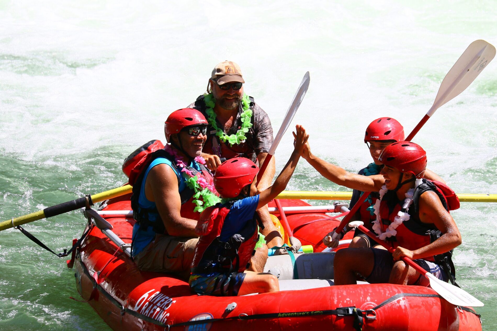 kids high-fiving after a successful rafting trip