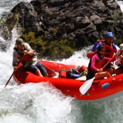three rafters on a white river