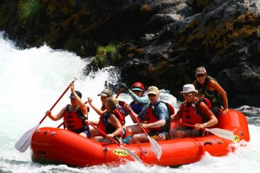 a team of seven rafting on a white river